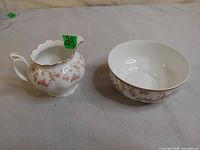 Creamer and sugar bowl side-by-side showing pattern and form