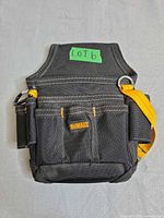 Front view of DeWalt tool belt pouch showing pockets and logo