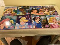 Eight Disney Me Reader books laid out on table