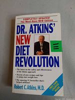 Front cover of the paperback book showing title, author photo and design