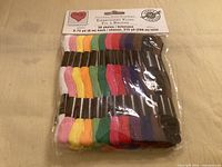 Front view of sealed pack showing 36 multicolour skeins and header card detailing length and quantity