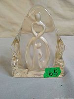 Front view of frosted and clear glass parent and child figurine with maker sticker visible