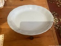 Top view of white oval platter showing interior surface and scalloped rim