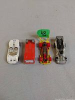 All four Hot Wheels cars lined up front view