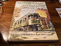 Front cover of hardcover book "Interurban Interlude" showing title, author and illustrated dust jacket