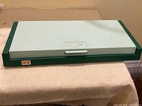 Closed green Keuffel & Esser Leroy case