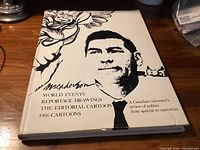 Front of hardcover book showing title, author name, subtitle, flower illustration, dust jacket tear