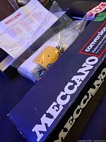 Navy Meccano conversion set box, sealed bag of yellow plate, gears, paperwork visible