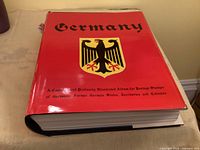 Front cover of red Minkus Germany stamp album inside slipcase