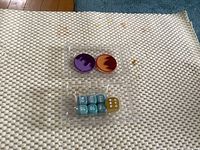 Front view of sealed tray showing two condition markers and dice