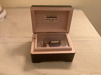 Music box open showing mechanism and Reuge label