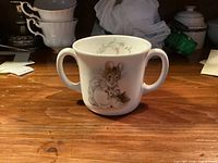 Front view showing Hunca Munca illustration and twin handles