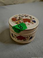 Closed trinket box showing floral lid and body pattern
