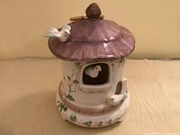 Front view of Schmid ceramic birdhouse music box showing birds and painted details