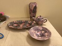 Group shot of sgraffito ceramic teapot, bowl, platter and vase
