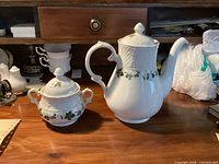 Coffee pot and sugar bowl on desk