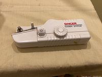 Top view of Singer Handy Stitch sewing machine showing branding and controls