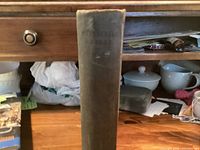 Spine of dark green cloth hardcover book