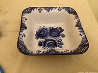 Top view of blue and white square porcelain bowl with floral motif
