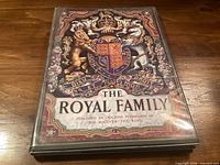 Front cover of The Royal Family booklet showing coat of arms and title