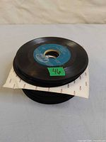 Stack of 45 rpm records with Reo label record on top