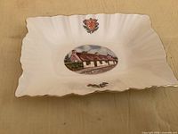 Top view showing fluted rim, gilding, crest, thistle, central Burns Cottage image