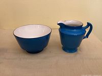 Front view of blue sugar bowl and creamer set