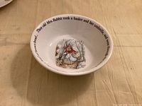 Top view of bowl showing interior illustration and portion of text.
