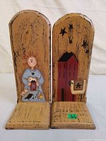 Front view of both wooden bookends showing painted designs and distressed finish