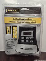 Front of sealed package showing brand, model, features, LCD screen, three-outlet design