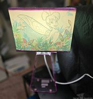 Full view of lamp lit showing Tinkerbell shade and clear pink base