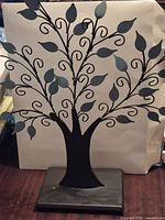 Full front view of Hallmark metal tree sculpture against light background