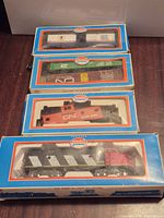 Four Model Power HO scale train pieces in original boxes stacked