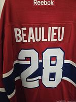 Rear view displaying BEAULIEU name and number 28 with Reebok branding.