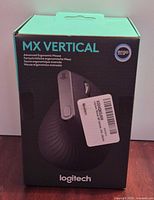 Front of sealed box showing Logitech MX Vertical mouse image and branding