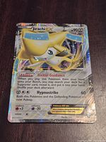 Front of Jirachi EX card showing artwork, text, and holographic pattern