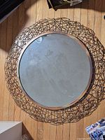 Front view of round Safavieh twig mirror