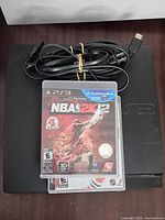 Console with cable and two game cases stacked