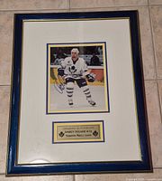 Full framed signed photo showing frame, matting and plaque