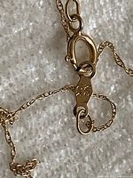 Close-up of lobster clasp and 10K hallmark tag