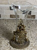 Full view of vase assembled showing glass insert and brass filigree holder