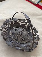 Top view of silver-plate basket showing floral openwork and handle
