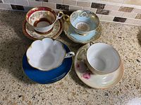 All four teacup and saucer sets displayed