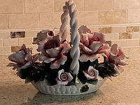 Front view of porcelain basket with roses and sticker visible