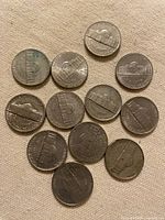 Reverse sides of 12 Jefferson nickels highlighting Monticello design