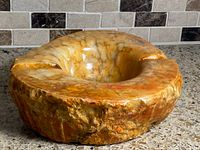 overall view of onyx ashtray showing shape, color, and cigar rests