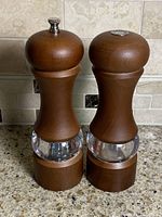 Front view of both mills showing wood bodies, acrylic bands, metal tops