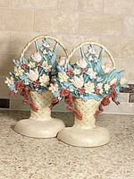 Front view of both cast iron floral basket bookends