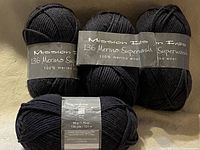 Front view of four skeins showing Mission Falls 136 Merino Superwash labels