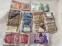 All eight banknotes laid out together showing fronts